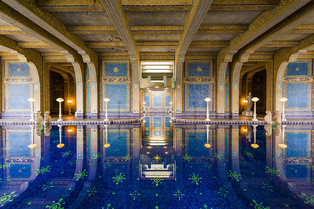 The indoor, Roman Pool at Hearst Castle, is tiled and decorated with eight statues of Roman gods, goddesses and heroes. The pool appears to be styled after an ancient Roman bath. Photo by  Weizhong/www.truphotos.com / Alamy Stock Photo