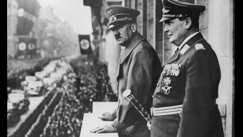 • Hermann Goring and Adolf Hitler watch a parade in Prussia 1938