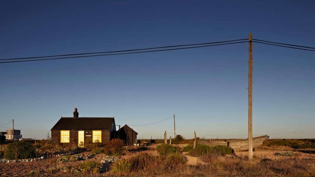 Prospect Cottage, the former home of the late British film director Derek Jarman. In the far-left background, the Dungeness Nuclear Power Station is visible.