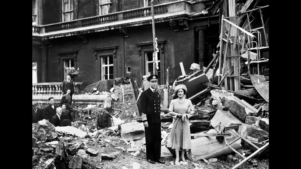 British King George and Queen Elizabeth stand amid WW II bomb damage at Buckingham Palace, September 1940