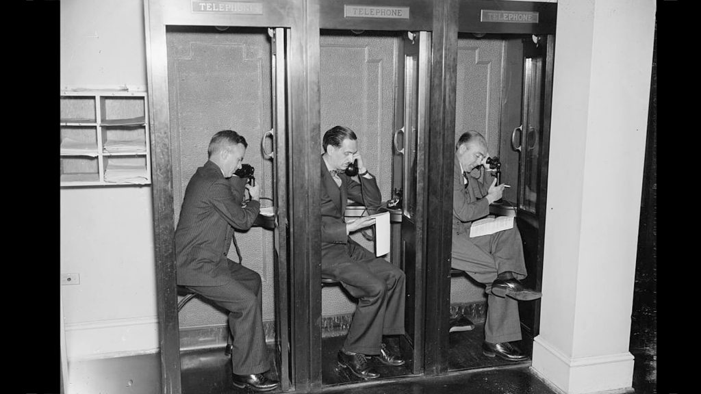 Reporters in phone booths at the White House press room, 1937.