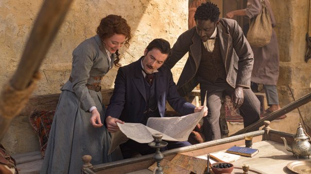Actors Leonie Benesch (as Abigail Fix), David Tennant (as Phileas Fogg), and Ibrahim Koma (as Jean Passsepartout) in an adaptation of Jules Verne's Around the World in 80 Days on MASTERPIECE on PBS.