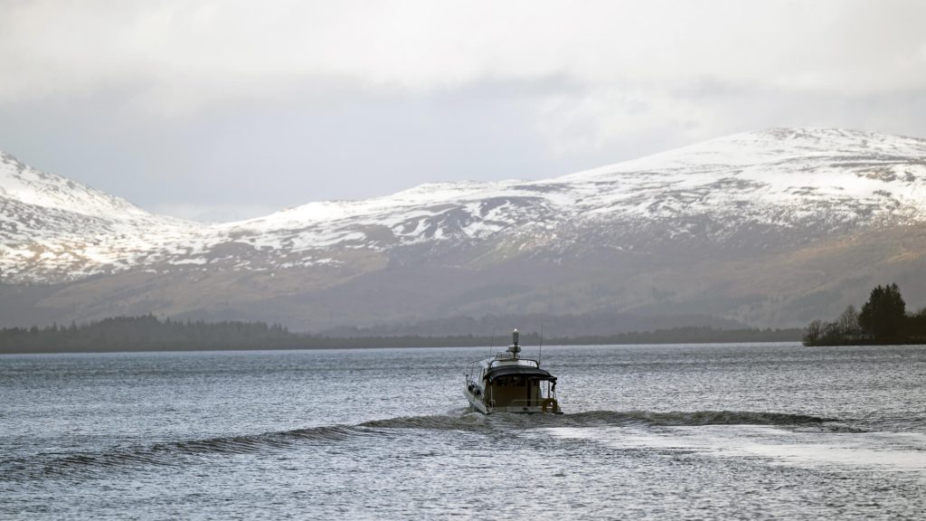 Motor boat in Scotish waters in a scene from Annika on MASTERPIECE on PBS.