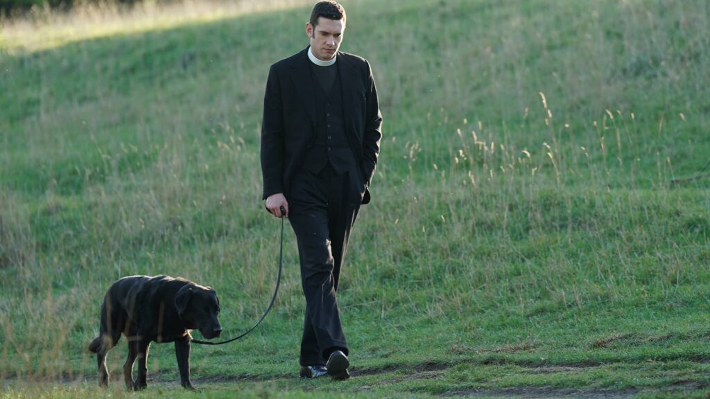 Tom Brittney as Will Davenport with dog Dickens in Grantchester Season 8