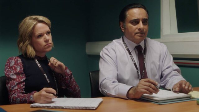 Sinéad Keenan and Sanjeev Bhaskar sitting in the interrogation room in Unforgotten Season 5
