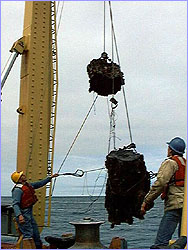 Le Olson (in yellow hat) brings the Roane chimney aboard.