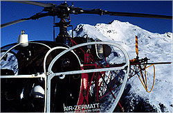 closeup of helicopter with mountain in background