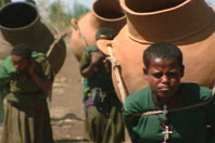 Women carrying clay pots