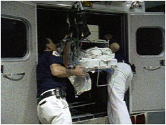 Loading Alex's gurney into a transfer ambulance