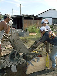 Photo of team pouring concrete into Moai mold