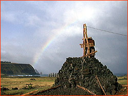 Photo of double rainbow over raised Moai