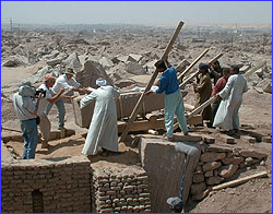 Levering small obelisk into pit