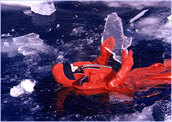 Man wearing immersion suit in ice water