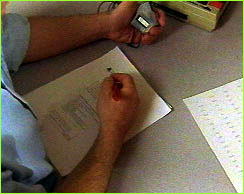 Person administering test with sheet of questions and stopwatch