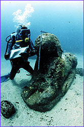 Diver making notes on sphinx