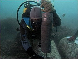 Diver attaching lead line to corner of block