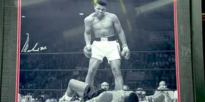 Framed photo of Muhammad Ali standing over Sonny Liston lying on the mat during their boxing match in May 1965