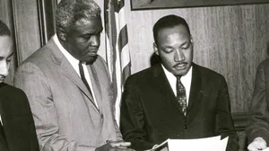 Photograph of Jackie Robinson and Martin Luther King Jr. discussing Civil Rights legislation, March 5, 1964