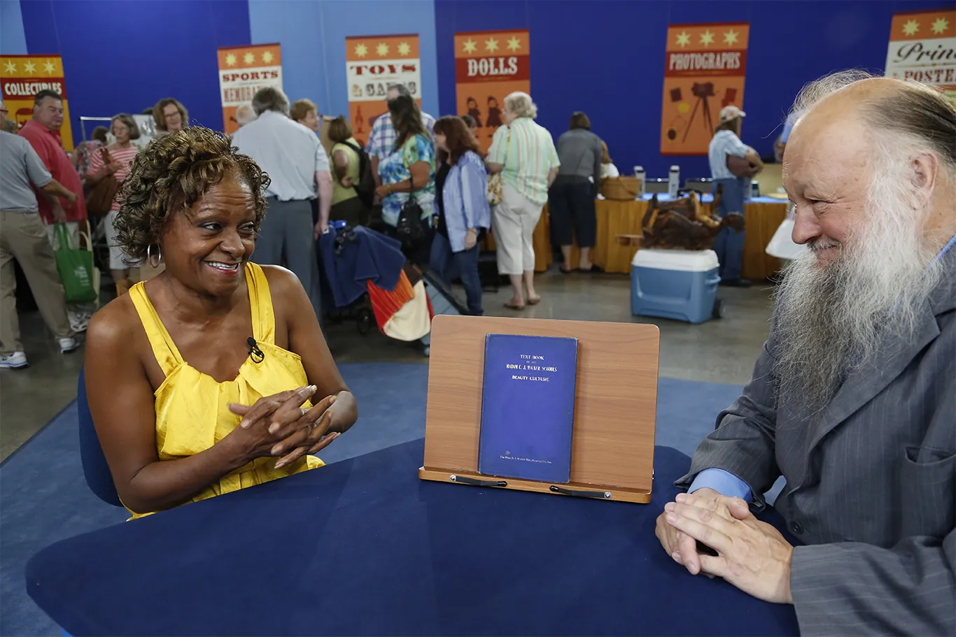 Appraiser Ken Sanders appraises a Madam C.J. Walker beauty text book in Kansas City.